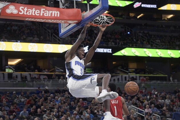 Orlando Magic center Mo Bamba (5) dunks the ball in front of Washington Wizards forward Trevor Ariza (1) during the second half of an NBA basketball game Friday, Jan. 25, 2019, in Orlando, Fla. (AP Photo/Phelan M. Ebenhack)