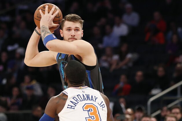 Dallas Mavericks forward Luka Doncic (77) looks to pass as New York Knicks Tim Hardaway Jr. defends him during the first half of an NBA basketball game, Wednesday, Jan. 30, 2019, in New York. (AP Photo/Kathy Willens)