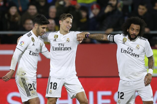 Real Madrid's Marcos Llorente, center, celebrates after scoring against Girona during a Spanish Copa del Rey soccer match at the Montilivi stadium in Girona, Spain, Thursday, Jan. 31, 2019. (AP Photo/Manu Fernandez)