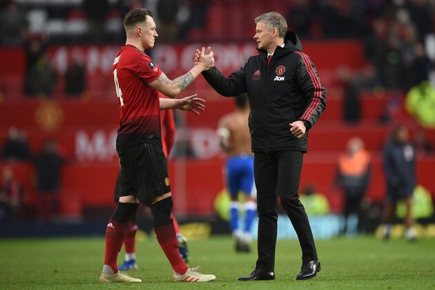 Manchester United's  Norwegian caretaker manager Ole Gunnar Solskjaer (R) greets Manchester United's English defender Phil Jones (L) at the end of the English FA Cup third round football match between Manchester United and Reading at Old Trafford in Manchester, north west England, on January 5, 2019. (Photo by Oli SCARFF / AFP) / RESTRICTED TO EDITORIAL USE. No use with unauthorized audio, video, data, fixture lists, club/league logos or 'live' services. Online in-match use limited to 120 images. An additional 40 images may be used in extra time. No video emulation. Social media in-match use limited to 120 images. An additional 40 images may be used in extra time. No use in betting publications, games or single club/league/player publications. /         (Photo credit should read OLI SCARFF/AFP/Getty Images)