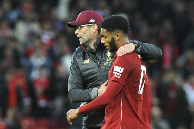 Liverpool manager Juergen Klopp hugs Liverpool's Joe Gomez after the English Premier League soccer match between Liverpool and Manchester City at Anfield stadium in Liverpool, England, Sunday, Oct. 7, 2018. (AP Photo/Rui Vieira)