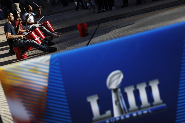 Ken Woolridge, from left, Carl Smith and Jerry Sims drum for fans outside the NFL Experience ahead of Sunday's Super Bowl 53 football game between the Los Angeles Rams and New England Patriots in Atlanta, Friday, Feb. 1, 2019. (AP Photo/David Goldman)