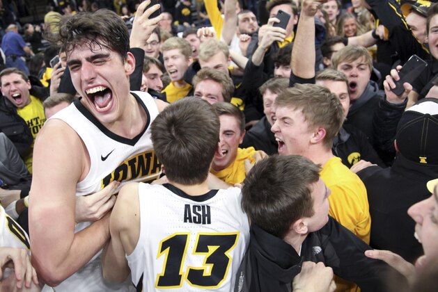 IOWA CITY, IOWA- FEBRUARY 01:  Forward Luka Garza #55 and guard Austin Ash #13 of the Iowa Hawkeyes celebrates with fans after the upset over the Michigan Wolverines on February 1, 2019 at Carver-Hawkeye Arena, in Iowa City, Iowa.  (Photo by Matthew Holst/Getty Images)