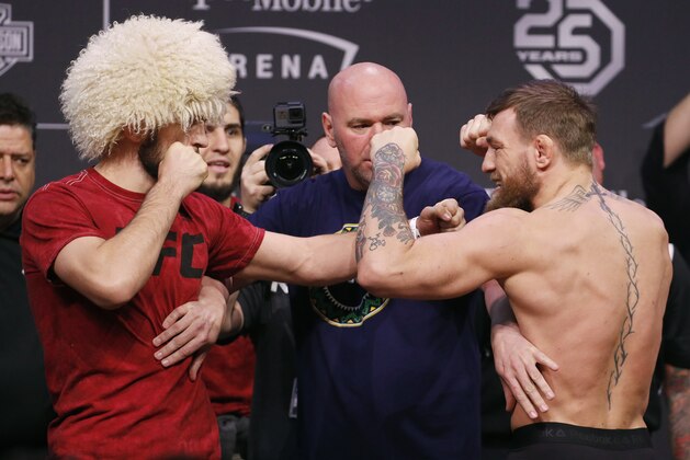 Conor McGregor, right, and Khabib Nurmagomedov face off during a ceremonial weigh-in for the UFC 229 mixed martial arts fight Friday, Oct. 5, 2018, in Las Vegas. (AP Photo/John Locher)