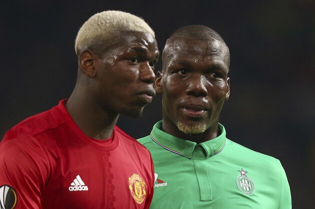 Manchester United's Paul Pogba, left, and St.-Etienne's Florentin Pogba during the Europa League round of 32 first leg soccer match between Manchester United and St.-Etienne at the Old Trafford stadium in Manchester, England, Thursday, Feb. 16, 2017 . (AP Photo/Dave Thompson)