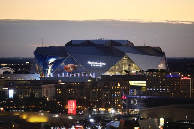 The sun sets behind Mercedes-Benz Stadium ahead of Sunday's NFL Super Bowl 53 football game between the Los Angeles Rams and New England Patriots in Atlanta, Friday, Feb. 1, 2019. (AP Photo/David Goldman)