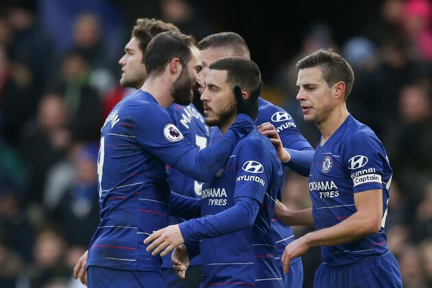 Chelsea's Belgian midfielder Eden Hazard (C) celebrates scoring their second goal from the penalty spot with Chelsea's Argentinian striker Gonzalo Higuain (L) during the English Premier League football match between Chelsea and Huddersfield Town at Stamford Bridge in London on February 2, 2019. (Photo by Daniel LEAL-OLIVAS / AFP) / RESTRICTED TO EDITORIAL USE. No use with unauthorized audio, video, data, fixture lists, club/league logos or 'live' services. Online in-match use limited to 120 images. An additional 40 images may be used in extra time. No video emulation. Social media in-match use limited to 120 images. An additional 40 images may be used in extra time. No use in betting publications, games or single club/league/player publications. /         (Photo credit should read DANIEL LEAL-OLIVAS/AFP/Getty Images)