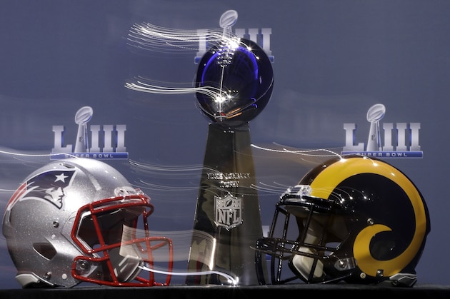 In this image taken with a slow shutter speed, the Vince Lombardi Trophy is displayed before a news conference for the NFL Super Bowl 53 football game Wednesday, Jan. 30, 2019, in Atlanta. (AP Photo/David J. Phillip)