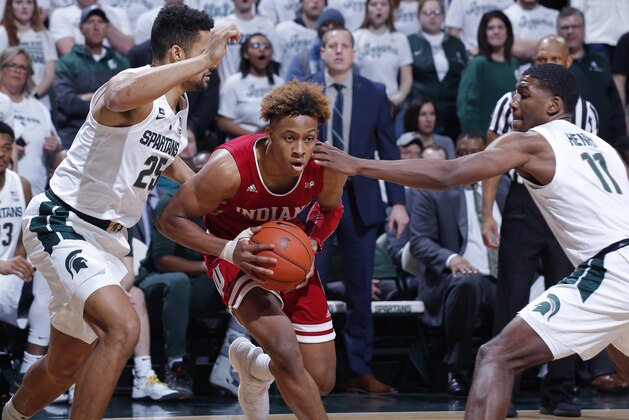 Indiana's Romeo Langford, center, drives between Michigan State's Kenny Goins, left, and Aaron Henry (11) during the first half of an NCAA college basketball game, Saturday, Feb. 2, 2019, in East Lansing, Mich. (AP Photo/Al Goldis)