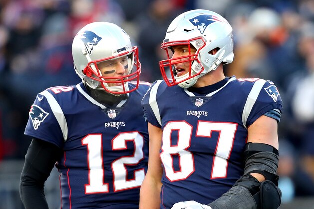 FOXBOROUGH, MASSACHUSETTS - JANUARY 13: Tom Brady #12 of the New England Patriots reacts with Rob Gronkowski #87 during the third quarter in the AFC Divisional Playoff Game against the Los Angeles Chargers at Gillette Stadium on January 13, 2019 in Foxborough, Massachusetts. (Photo by Maddie Meyer/Getty Images)