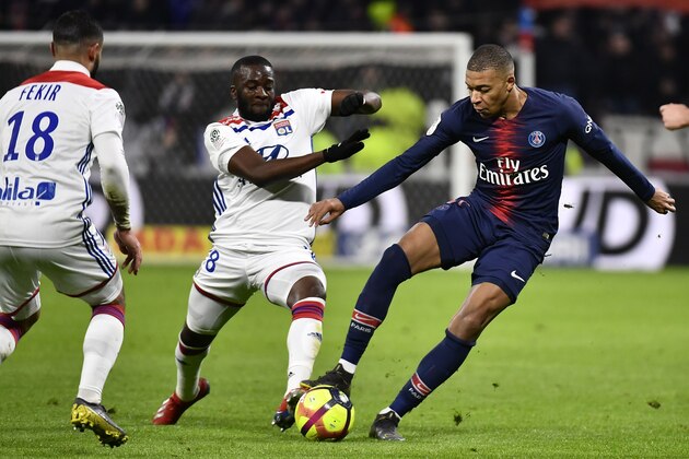 Paris Saint-Germain's French forward Kylian Mbappe (R) fights for the ball with Lyon's French forward Tanguy NDombele (C) and Lyon's French forward Nabil Fekir (L) during the French L1 football match between Olympique Lyonnais (OL) and Paris-Saint Germain (PSG) at Groupama stadium in Decines-Charpieu, near Lyon, on February 3, 2019. (Photo by JEFF PACHOUD / AFP)        (Photo credit should read JEFF PACHOUD/AFP/Getty Images)