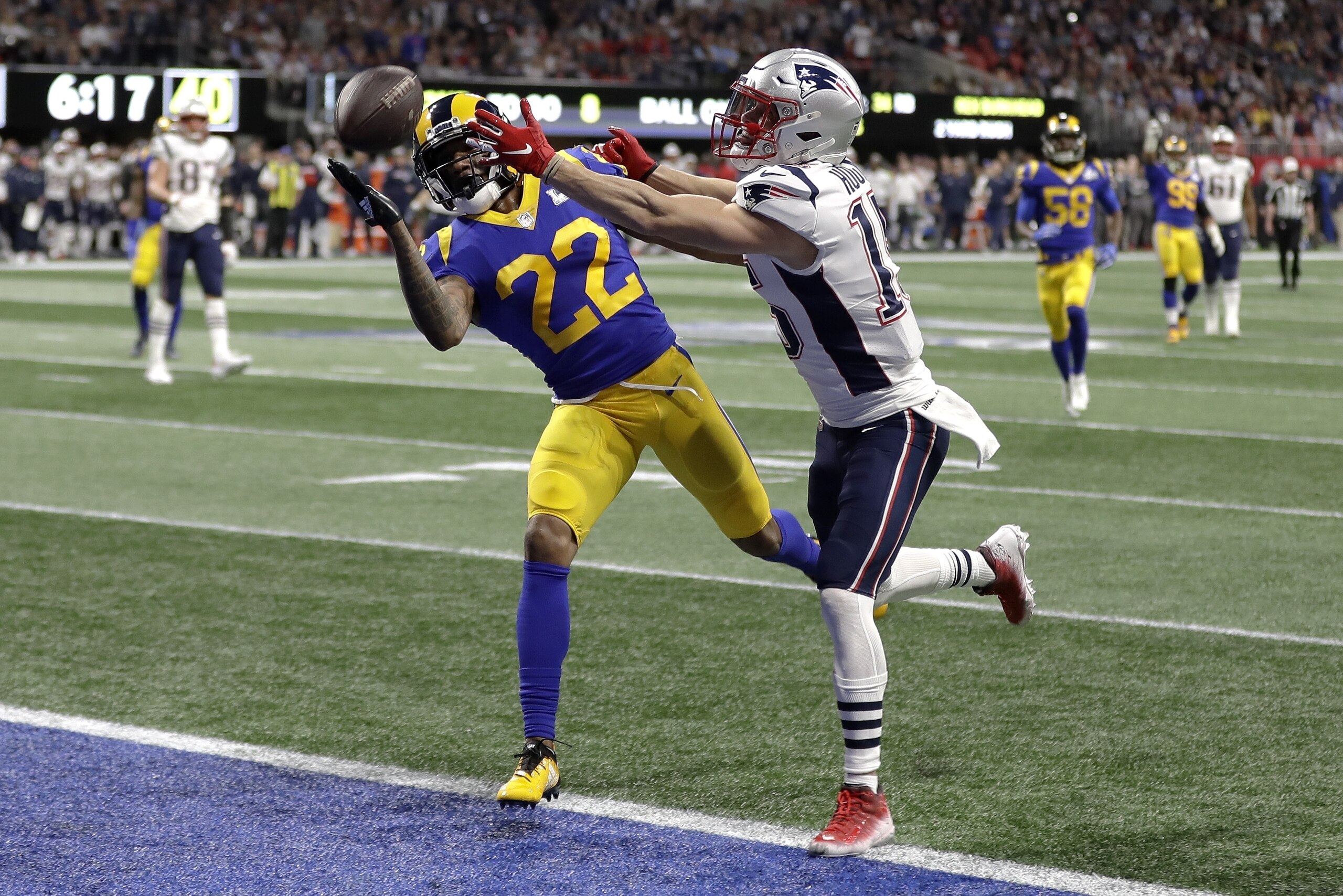 Los Angeles Rams' Marcus Peters (22), left, breaks up a pass intended for New England Patriots' Chris Hogan during the first half of the NFL Super Bowl 53 football game Sunday, Feb. 3, 2019, in Atlanta. (AP Photo/David J. Phillip)