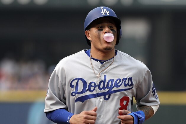 Los Angeles Dodgers' Manny Machado blows a bubble after hitting a single against the Seattle Mariners in a baseball game Sunday, Aug. 19, 2018, in Seattle. The Dodgers won 12-1. (AP Photo/Elaine Thompson)