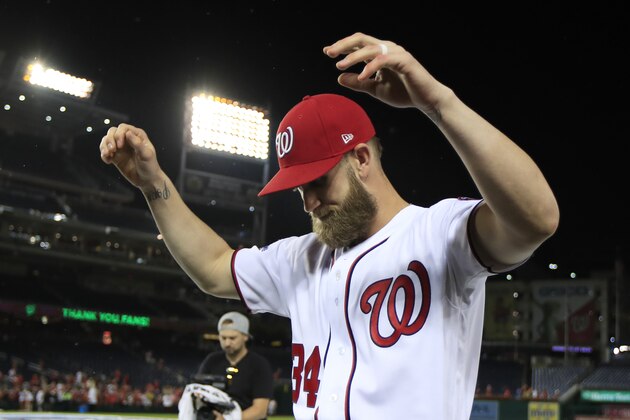 Washington Nationals Bryce Harper (34) gestures to their fans as the Nationals celebrate and bid goodbye to their fans ending their last home game of the season with a 9-3 rain delayed win against the Miami Marlins in Washington, Wednesday, Sept. 26, 2018. (AP Photo/Manuel Balce Ceneta)