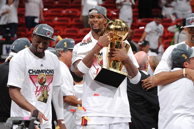 MIAMI, FL - JUNE 21:Dwyane Wade #3 and Chris Bosh #1 of the Miami Heat celebrates winning the Championship with the Larry O'Brien Trophy against the Oklahoma City Thunder during Game Five of the 2012 NBA Finals at American Airlines Arena on June 21, 2012 in Miami, Florida. NOTE TO USER: User expressly acknowledges and agrees that, by downloading and or using this Photograph, user is consenting to the terms and conditions of the Getty Images License Agreement. Mandatory Copyright Notice: Copyright 2012 NBAE (Photo by Garrett Ellwood/NBAE via Getty Images)
