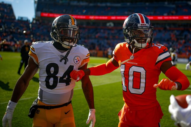 DENVER, CO - NOVEMBER 25:  Wide receiver Emmanuel Sanders #10 of the Denver Broncos talks with wide receiver JuJu Smith-Schuster #19 and wide receiver Antonio Brown #84 of the Pittsburgh Steelers as players warm up before a game at Broncos Stadium at Mile High on November 25, 2018 in Denver, Colorado. (Photo by Justin Edmonds/Getty Images)
