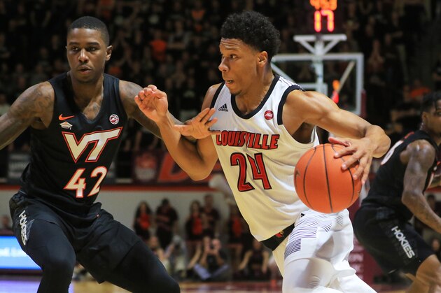BLACKSBURG, VA - FEBRUARY 04: Dwayne Sutton #24 of the Louisville Cardinals looks to dribble while being guarded by Ahmed Hill #13 and Ty Outlaw #42 of the Virginia Tech Hokies in the first half at Cassell Coliseum on February 04, 2019 in Blacksburg, Virginia. (Photo by Lauren Rakes/Getty Images)