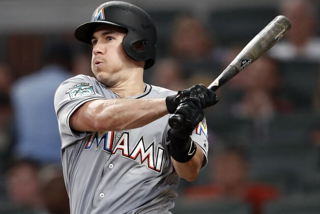 Miami Marlins' J.T. Realmuto follows through on two-run base hit in the fourth inning of a baseball game against the Atlanta Braves Tuesday, Aug. 14, 2018 in Atlanta. (AP Photo/John Bazemore)