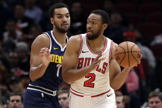 Chicago Bulls forward Jabari Parker, right, is defended by Denver Nuggets forward Trey Lyles during the first half of an NBA preseason basketball game Friday, Oct. 12, 2018, in Chicago. (AP Photo/Nam Y. Huh)
