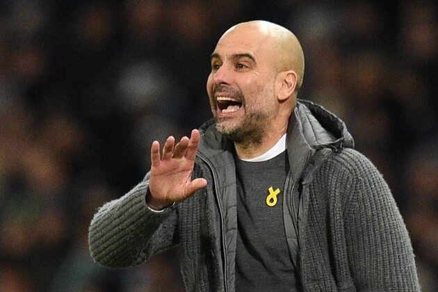 Manchester City's Spanish manager Pep Guardiola gestures from the touchline wearing a yellow ribbon on his shirt during the English Premier League football match between Manchester City and Arsenal at the Etihad Stadium in Manchester, north west England, on February 3, 2019. (Photo by Oli SCARFF / AFP) / RESTRICTED TO EDITORIAL USE. No use with unauthorized audio, video, data, fixture lists, club/league logos or 'live' services. Online in-match use limited to 120 images. An additional 40 images may be used in extra time. No video emulation. Social media in-match use limited to 120 images. An additional 40 images may be used in extra time. No use in betting publications, games or single club/league/player publications. /         (Photo credit should read OLI SCARFF/AFP/Getty Images)