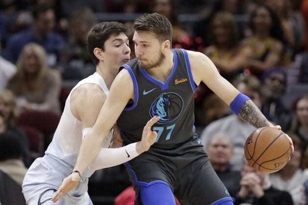 Dallas Mavericks' Luka Doncic (77), from Slovenia, drives past Cleveland Cavaliers' Cedi Osman (16), from Turkey, in the first half of an NBA basketball game, Saturday, Feb. 2, 2019, in Cleveland. (AP Photo/Tony Dejak)