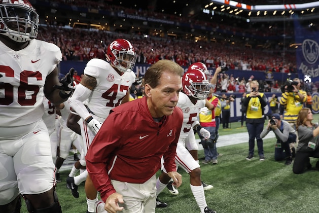 Alabama head coach Nick Saban runs out tot he bench area with his team ahead of the Southeastern Conference championship NCAA college football game between Georgia and Alabama, Saturday, Dec. 1, 2018, in Atlanta. (AP Photo/John Bazemore)