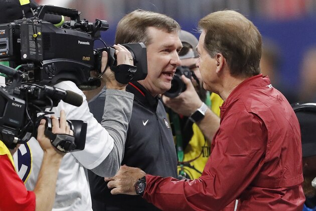 Georgia head coach Kirby Smart, left, speaks with Alabama head coach Nick Saban ahead of the Southeastern Conference championship NCAA college football game between Georgia and Alabama, Saturday, Dec. 1, 2018, in Atlanta. (AP Photo/John Bazemore)