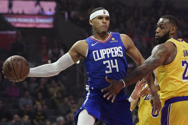 Los Angeles Clippers forward Tobias Harris, left, passes the ball as Los Angeles Lakers forward LeBron James defends during the first half of an NBA basketball game Thursday, Jan. 31, 2019, in Los Angeles. (AP Photo/Mark J. Terrill)