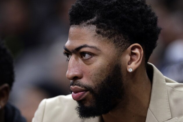 New Orleans Pelicans forward Anthony Davis watches from the bench in street clothes during the first half of the team's NBA basketball game against the San Antonio Spurs in San Antonio, Saturday, Feb. 2, 2019. (AP Photo/Eric Gay)