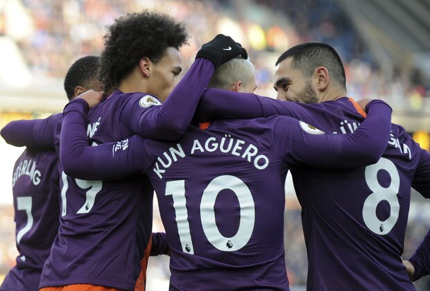 Manchester City's Leroy Sane, second from left, celebrates with his teammates Raheem Sterling, left, Sergio Aguero and Ilkay Gundogan, after scoring the third goal for his team, during the English Premier League soccer match between Huddersfield Town and Manchester City at John Smith's stadium in Huddersfield, England, Sunday, Jan. 20, 2019. (AP Photo/Rui Vieira)