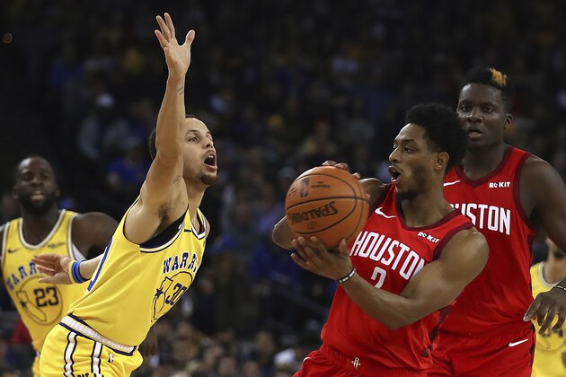 Houston Rockets' Brandon Knight, right, looks to pass the ball away from Golden State Warriors' Stephen Curry (30) during the first half of an NBA basketball game Thursday, Jan. 3, 2019, in Oakland, Calif. (AP Photo/Ben Margot)