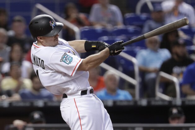 Miami Marlins' J.T. Realmuto hits a single during the fourth inning of a baseball game against the San Francisco Giants on Wednesday, June 13, 2018, in Miami. (AP Photo/Lynne Sladky)