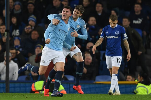 Manchester City's French defender Aymeric Laporte (L) celebrates scoring the opening goal during the English Premier League football match between Everton and Manchester City at Goodison Park in Liverpool, north west England on February 6, 2019. (Photo by Paul ELLIS / AFP) / RESTRICTED TO EDITORIAL USE. No use with unauthorized audio, video, data, fixture lists, club/league logos or 'live' services. Online in-match use limited to 120 images. An additional 40 images may be used in extra time. No video emulation. Social media in-match use limited to 120 images. An additional 40 images may be used in extra time. No use in betting publications, games or single club/league/player publications. /         (Photo credit should read PAUL ELLIS/AFP/Getty Images)