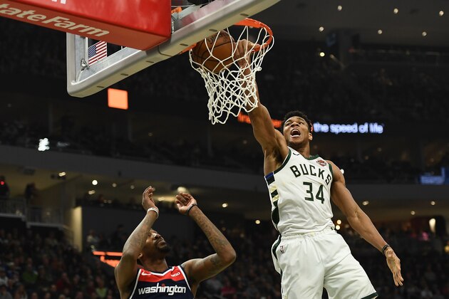 MILWAUKEE, WISCONSIN - FEBRUARY 06:  Giannis Antetokounmpo #34 of the Milwaukee Bucks dunks in front of Jordan McRae #52 of the Washington Wizards during the first half of a game at Fiserv Forum on February 06, 2019 in Milwaukee, Wisconsin.  NOTE TO USER: User expressly acknowledges and agrees that, by downloading and or using this photograph, User is consenting to the terms and conditions of the Getty Images License Agreement. (Photo by Stacy Revere/Getty Images)