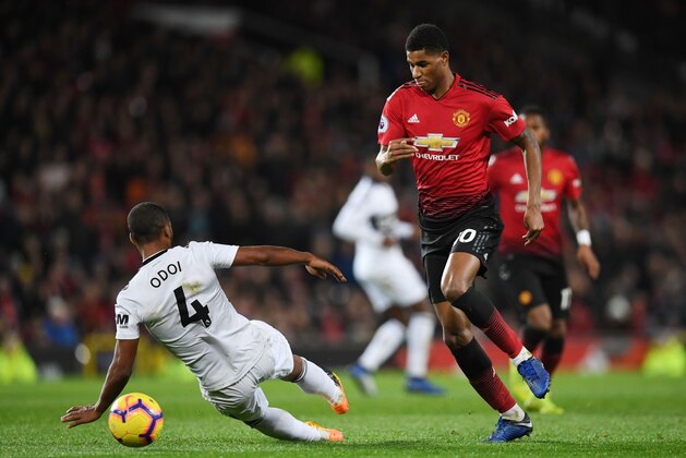 Manchester United's English striker Marcus Rashford (R) vies with Fulham's Belgian defender Denis Odoi during the English Premier League football match between Manchester United and Fulham at Old Trafford in Manchester, north west England, on December 8, 2018. (Photo by Paul ELLIS / AFP) / RESTRICTED TO EDITORIAL USE. No use with unauthorized audio, video, data, fixture lists, club/league logos or 'live' services. Online in-match use limited to 120 images. An additional 40 images may be used in extra time. No video emulation. Social media in-match use limited to 120 images. An additional 40 images may be used in extra time. No use in betting publications, games or single club/league/player publications. /         (Photo credit should read PAUL ELLIS/AFP/Getty Images)