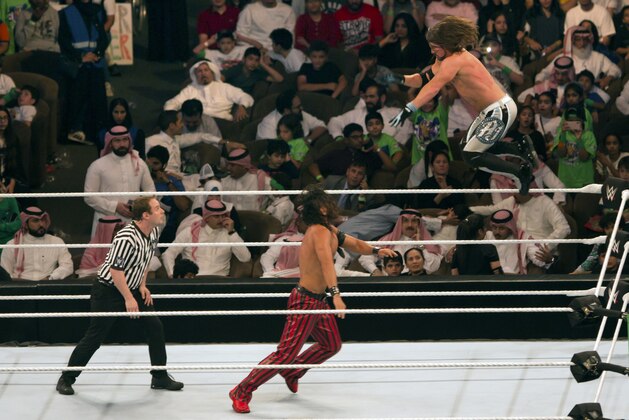 World Wrestling Entertainment stars AJ Styles, top, and Shinsuke Nakamura, wrestle during their match at the World Wrestling Entertainment stars AJ Styles, top, and Shinsuke Nakamura, wrestle during their match at the