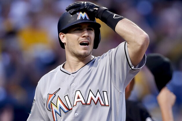 FILE - In this Friday, Sept. 7, 2018, file photo, Miami Marlins' J.T. Realmuto heads back to the dugout after striking out against the Pittsburgh Pirates in the first inning of a baseball game, in Pittsburgh. The agent for catcher J.T. Realmuto says his client has informed the Miami Marlins he won’t sign a long-term contract, increasing the likelihood the team will trade yet another All-Star. (AP Photo/Keith Srakocic, File)