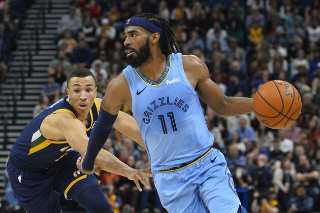 Memphis Grizzlies guard Mike Conley (11) drives past Utah Jazz guard Dante Exum (11) during the first half of an NBA basketball game Friday, Nov. 2, 2018, in Salt Lake City. (AP Photo/Alex Goodlett)