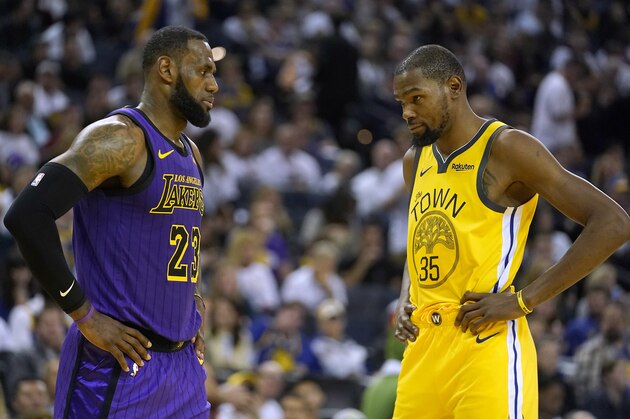 Los Angeles Lakers forward LeBron James (23) talks to Golden State Warriors forward Kevin Durant during the second half of an NBA basketball game Tuesday, Dec. 25, 2018, in Oakland, Calif. The Lakers won 127-101. (AP Photo/Tony Avelar)