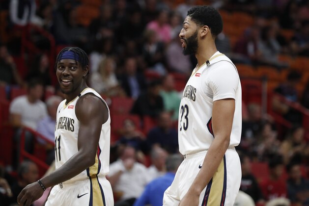 New Orleans Pelicans forward Anthony Davis, right, and New Orleans Pelicans guard Jrue Holiday, left, in action during an NBA basketball game Friday, Nov. 30, 2018, in Miami. (AP Photo/Brynn Anderson)