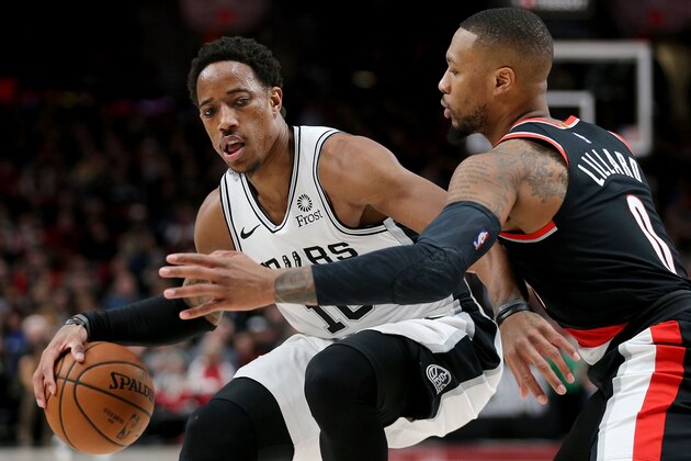 PORTLAND, OR - FEBRUARY 07: DeMar DeRozan #10 of the San Antonio Spurs dribbles against Damian Lillard #0 of the Portland Trail Blazers in the second quarter during their game at Moda Center on February 7, 2019 in Portland, Oregon. NOTE TO USER: User expressly acknowledges and agrees that, by downloading and or using this photograph, User is consenting to the terms and conditions of the Getty Images License Agreement.  (Photo by Abbie Parr/Getty Images)