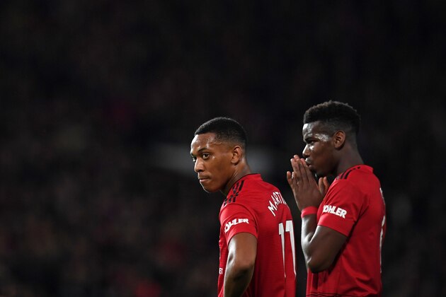 Manchester United's French striker Anthony Martial (L) and Manchester United's French midfielder Paul Pogba (R) take a break during the English Premier League football match between Manchester United and Bournemouth at Old Trafford in Manchester, north west England, on December 30, 2018. (Photo by Paul ELLIS / AFP) / RESTRICTED TO EDITORIAL USE. No use with unauthorized audio, video, data, fixture lists, club/league logos or 'live' services. Online in-match use limited to 120 images. An additional 40 images may be used in extra time. No video emulation. Social media in-match use limited to 120 images. An additional 40 images may be used in extra time. No use in betting publications, games or single club/league/player publications. /         (Photo credit should read PAUL ELLIS/AFP/Getty Images)