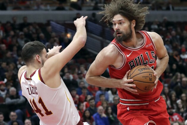 Chicago Bulls center Robin Lopez, right, drives against Cleveland Cavaliers center Ante Zizic during the first half of an NBA basketball game Sunday, Jan. 27, 2019, in Chicago. (AP Photo/Nam Y. Huh)