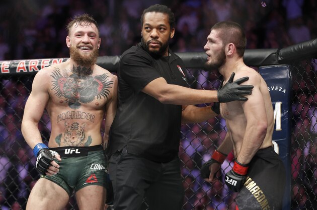 FILE - In this Oct. 6, 2018, file photo, Conor McGregor, left, fights Khabib Nurmagomedov are separated during a UFC 229 mixed martial arts bout in Las Vegas. Nurmagomedov was fined $500,000 and suspended for nine months for a brawl inside and outside the octagon after his fight with Conor McGregor at UFC 229. McGregor was fined $50,000 and suspended for six months.  The suspensions for both fighters are retroactive to Oct. 6. (AP Photo/John Locher, File)