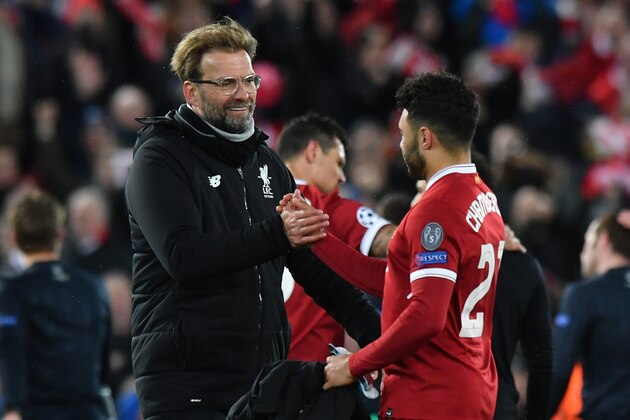 Liverpool's German manager Jurgen Klopp (L) gestures with Liverpool's English midfielder Alex Oxlade-Chamberlain at the final whistle during the UEFA Champions League first leg quarter-final football match between Liverpool and Manchester City, at Anfield stadium in Liverpool, north west England on April 4, 2018. / AFP PHOTO / Anthony Devlin        (Photo credit should read ANTHONY DEVLIN/AFP/Getty Images)