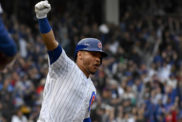 Chicago Cubs' Willson Contreras (40) raises his arm after he hit a two run home run during the fifth inning of a baseball game against the St. Louis Cardinals on Sunday, Sept. 30, 2018, in Chicago. (AP Photo/Matt Marton)