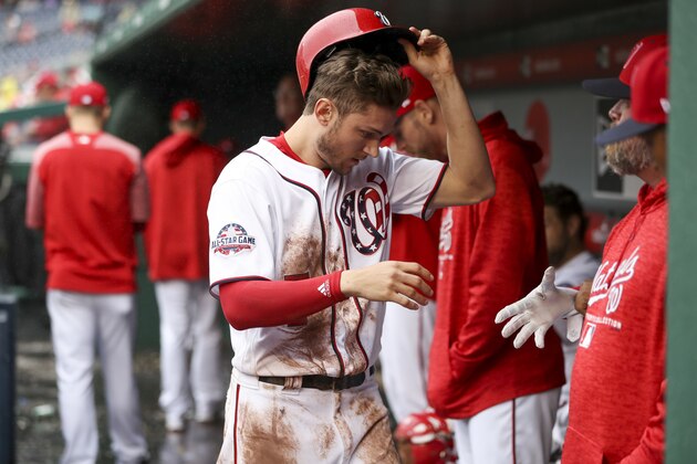 Washington Nationals' Trea Turner walks back into the dugout after scoring on a double by Bryce Harper in the third inning of a baseball game against he New York Mets at Nationals Park, Sunday, Sept. 23, 2018, in Washington. Turner stole second base, setting a team record for career stolen bases. (AP Photo/Andrew Harnik)