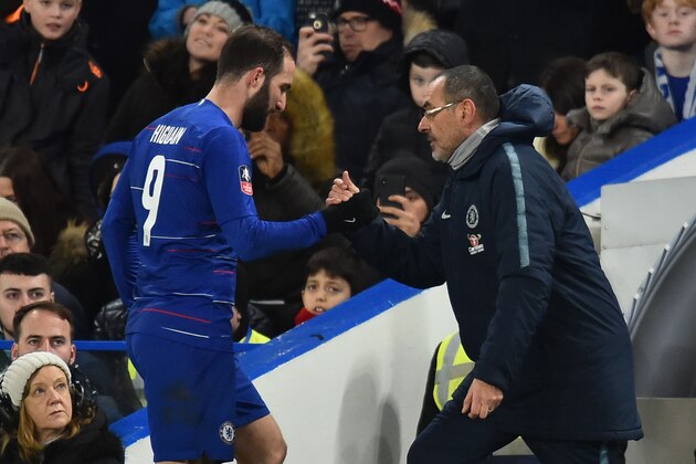 Chelsea's Argentinian striker Gonzalo Higuain (L) shakes hands with Chelsea's Italian head coach Maurizio Sarri (R) as he comes off as a substitute during the English FA Cup fourth round football match between Chelsea and Sheffield Wednesday at Stamford Bridge in London on January 27, 2019. (Photo by Glyn KIRK / AFP) / RESTRICTED TO EDITORIAL USE. No use with unauthorized audio, video, data, fixture lists, club/league logos or 'live' services. Online in-match use limited to 120 images. An additional 40 images may be used in extra time. No video emulation. Social media in-match use limited to 120 images. An additional 40 images may be used in extra time. No use in betting publications, games or single club/league/player publications. /         (Photo credit should read GLYN KIRK/AFP/Getty Images)