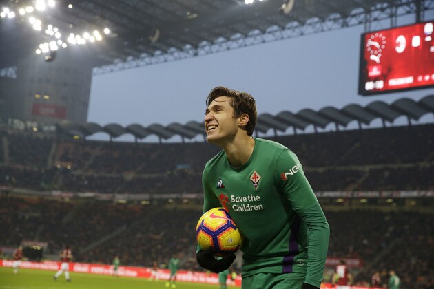 Fiorentina's Federico Chiesa smiles as he holds the ball during a Serie A soccer match between AC Milan and Fiorentina, at the San Siro stadium in Milan, Italy, Saturday, Dec. 22, 2018. (AP Photo/Luca Bruno)