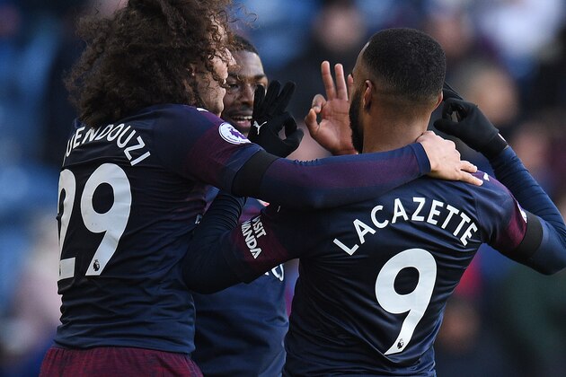 Arsenal's French striker Alexandre Lacazette (R) celebrates scoring his team's second goal with Arsenal's English midfielder Ainsley Maitland-Niles goal during the English Premier League football match between Huddersfield Town and Arsenal at the John Smith's stadium in Huddersfield, northern England on February 9, 2019. (Photo by Oli SCARFF / AFP) / RESTRICTED TO EDITORIAL USE. No use with unauthorized audio, video, data, fixture lists, club/league logos or 'live' services. Online in-match use limited to 120 images. An additional 40 images may be used in extra time. No video emulation. Social media in-match use limited to 120 images. An additional 40 images may be used in extra time. No use in betting publications, games or single club/league/player publications. /         (Photo credit should read OLI SCARFF/AFP/Getty Images)